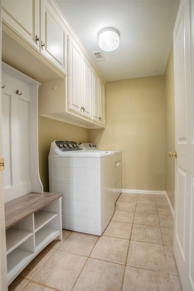 2115 Greentree Dr, Huntsville, TX 77340 - laundry room with cabinet space, independent washer and dryer, and light tile patterned floors
