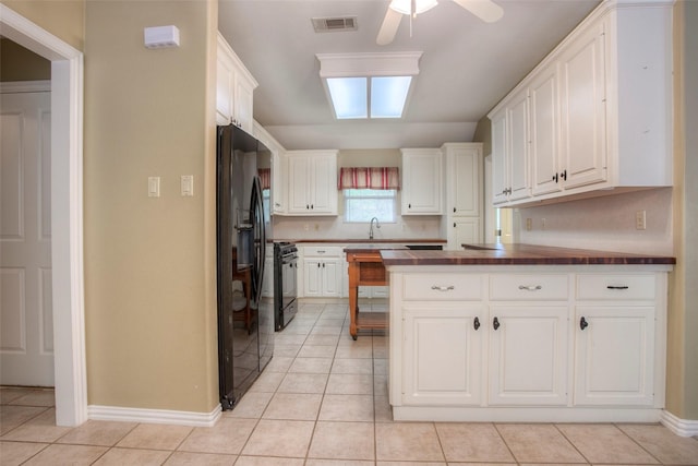 2115 Greentree Dr, Huntsville, TX 77340 - kitchen featuring black appliances, ceiling fan, light tile patterned flooring, and white cabinets