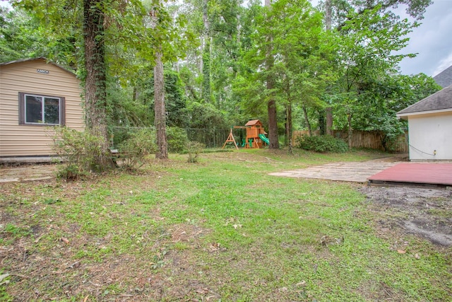 2115 Greentree Dr, Huntsville, TX 77340 - fenced backyard with a playground and a wooden deck