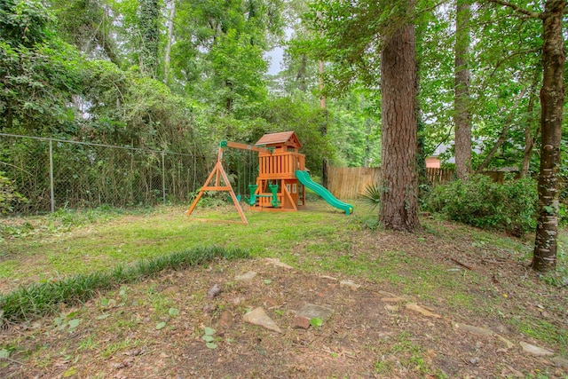2115 Greentree Dr, Huntsville, TX 77340 - fenced backyard featuring a playground