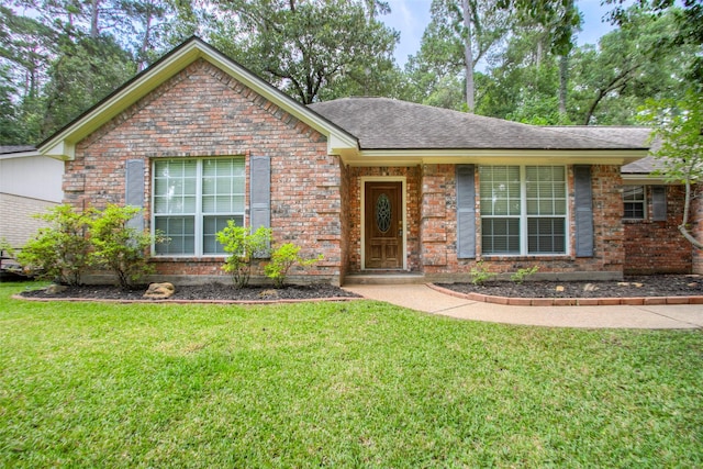 2115 Greentree Dr, Huntsville, TX 77340 - ranch-style home featuring brick siding, a front lawn, and roof with shingles