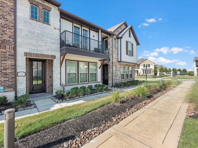 9440 Caddo Ridge Ln, Cypress, TX 77433 - townhome / multi-family property featuring a balcony and stone siding
