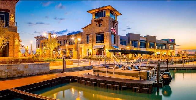 9440 Caddo Ridge Ln, Cypress, TX 77433 - pool at dusk with a floating dock and a water view