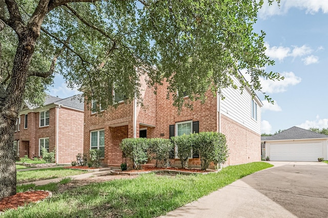 14212 Rocky Briar Ln, Rosharon, TX 77583 - view of front of house with brick siding, concrete driveway, a front yard, and an outdoor structure