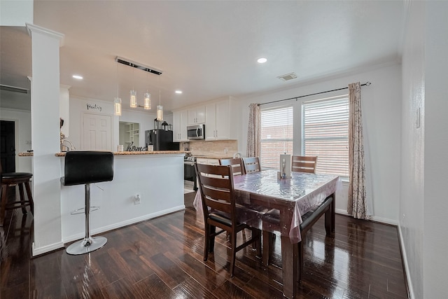 14212 Rocky Briar Ln, Rosharon, TX 77583 - dining room featuring dark wood finished floors, recessed lighting, and crown molding