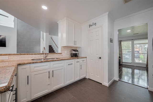 14212 Rocky Briar Ln, Rosharon, TX 77583 - kitchen with tasteful backsplash, light stone countertops, white cabinetry, ornamental molding, and recessed lighting