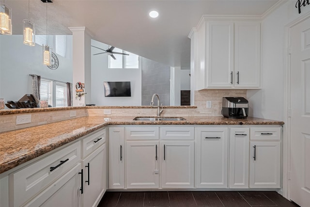 14212 Rocky Briar Ln, Rosharon, TX 77583 - kitchen with plenty of natural light, a ceiling fan, light stone counters, white cabinets, and recessed lighting