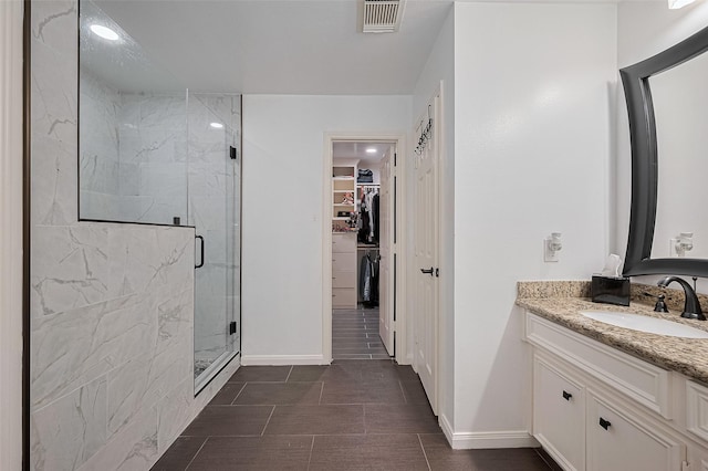 14212 Rocky Briar Ln, Rosharon, TX 77583 - full bathroom with vanity, a stall shower, and a walk in closet