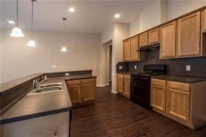 3510 Indian Mound Trl, Crosby, TX 77532 - kitchen with black electric range oven, dark countertops, dark wood-style floors, brown cabinets, and under cabinet range hood