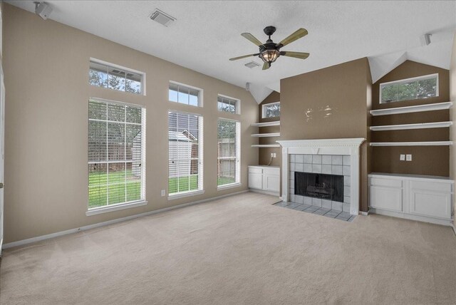 110 Crimson Bay Dr, League City, TX 77573 - unfurnished living room with carpet flooring, a tiled fireplace, ceiling fan, and a textured ceiling