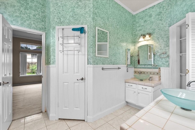 110 Crimson Bay Dr, League City, TX 77573 - bathroom featuring a wainscoted wall, vanity, tile patterned floors, crown molding, and wallpapered walls