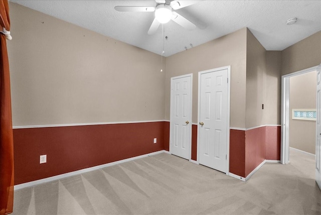 110 Crimson Bay Dr, League City, TX 77573 - unfurnished bedroom featuring light carpet, a ceiling fan, and a textured ceiling
