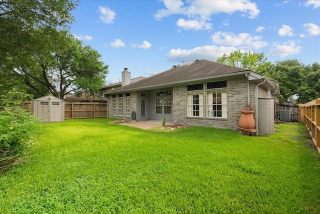 110 Crimson Bay Dr, League City, TX 77573 - rear view of property with a chimney, a storage unit, a fenced backyard, and a patio