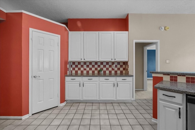 110 Crimson Bay Dr, League City, TX 77573 - kitchen featuring white cabinetry, backsplash, a textured ceiling, and light tile patterned flooring