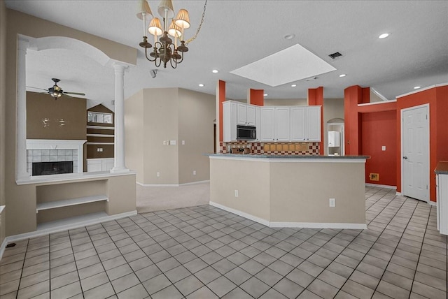 110 Crimson Bay Dr, League City, TX 77573 - kitchen featuring black microwave, a ceiling fan, white cabinetry, decorative columns, and a textured ceiling