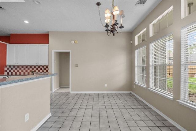 110 Crimson Bay Dr, League City, TX 77573 - unfurnished dining area with plenty of natural light, a chandelier, recessed lighting, and light tile patterned flooring