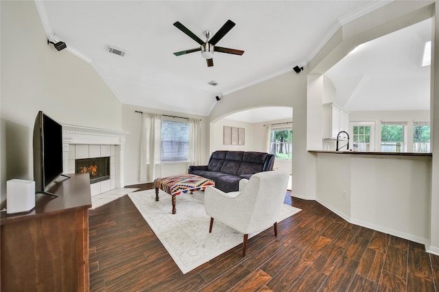55 Bowie Bend Ct, The Woodlands, TX 77385 - living room with vaulted ceiling, a ceiling fan, crown molding, plenty of natural light, and a fireplace