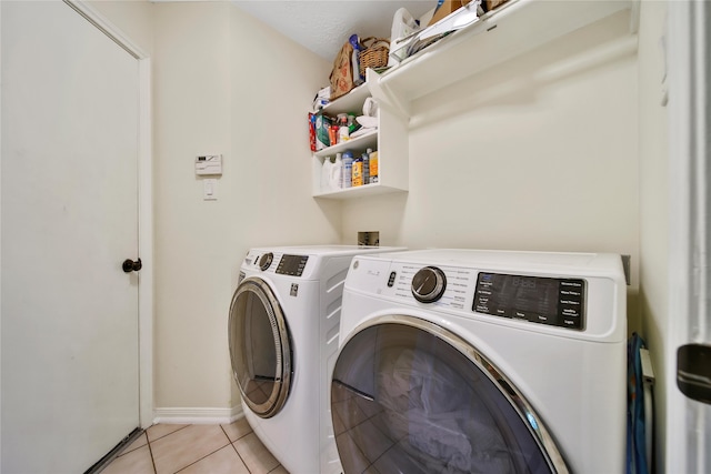 55 Bowie Bend Ct, The Woodlands, TX 77385 - washroom featuring separate washer and dryer and light tile patterned flooring
