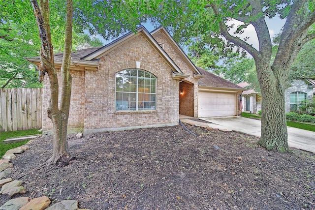 55 Bowie Bend Ct, The Woodlands, TX 77385 - view of front of home with brick siding, an attached garage, and concrete driveway
