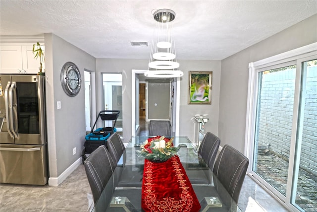 15902 Seven Springs Dr, Houston, TX 77084 - dining room featuring baseboards and a textured ceiling