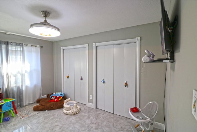 15902 Seven Springs Dr, Houston, TX 77084 - bedroom featuring two closets and baseboards