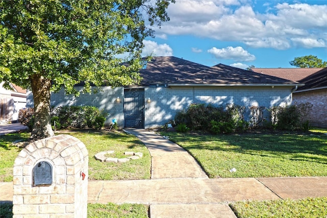 15902 Seven Springs Dr, Houston, TX 77084 - view of front facade featuring a front yard, brick siding, and a shingled roof