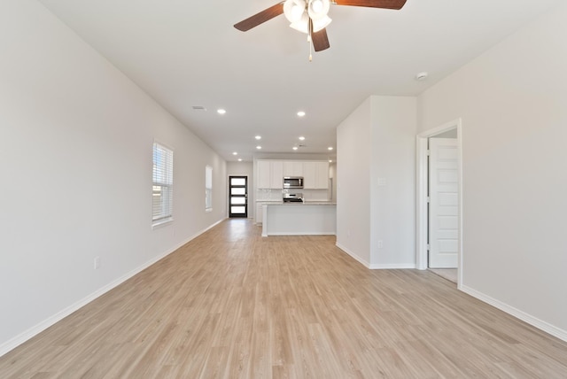 5827 Fresh View Ct, Katy, TX 77493 - unfurnished living room with a ceiling fan, light wood finished floors, and recessed lighting