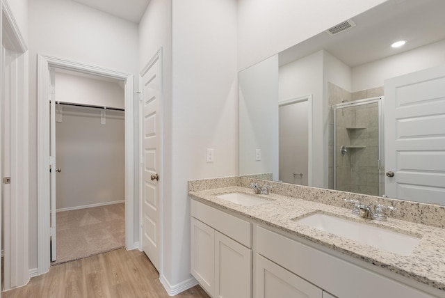 5827 Fresh View Ct, Katy, TX 77493 - full bath featuring a stall shower, a spacious closet, double vanity, and wood finished floors