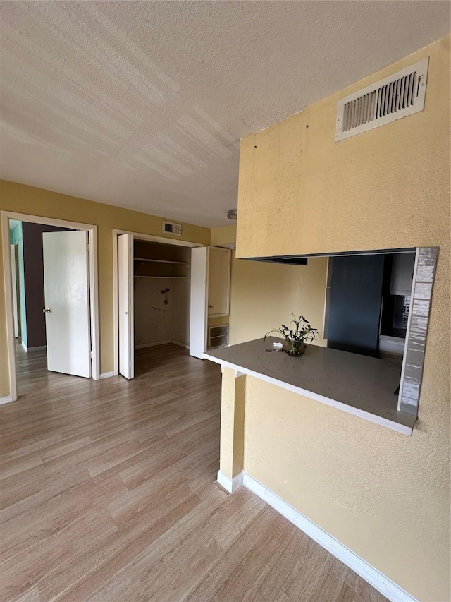 6161 Reims Rd Unit 611, Houston, TX 77036 - spare room with light wood-style floors and a textured ceiling