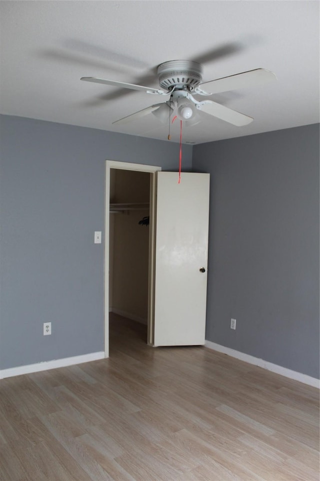 6161 Reims Rd Unit 611, Houston, TX 77036 - unfurnished bedroom with light wood finished floors, a closet, ceiling fan, and a spacious closet
