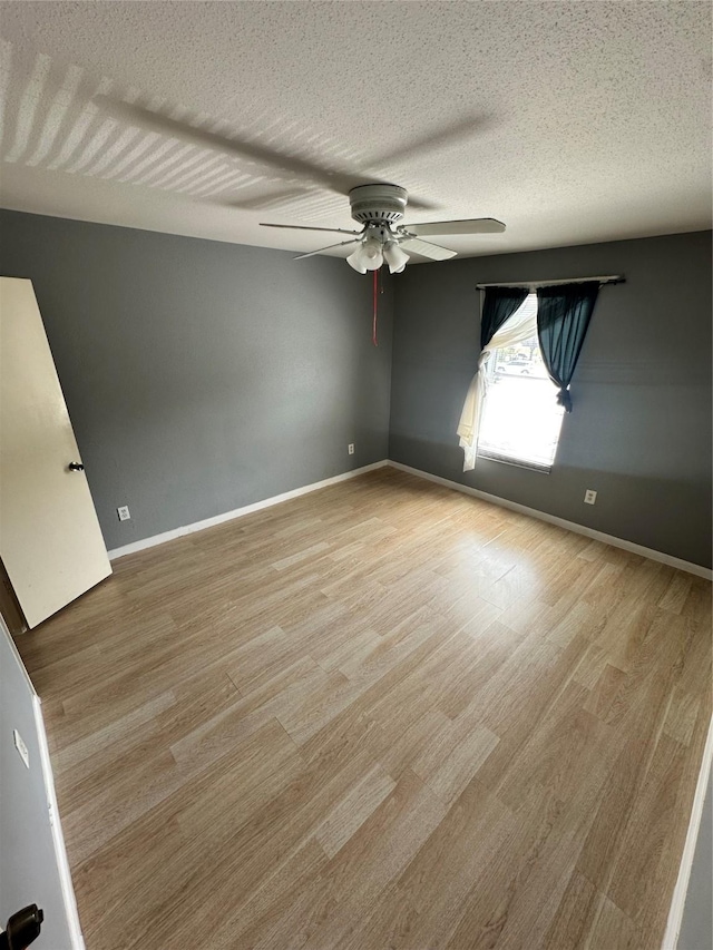 6161 Reims Rd Unit 611, Houston, TX 77036 - unfurnished room featuring a ceiling fan, light wood-type flooring, and a textured ceiling
