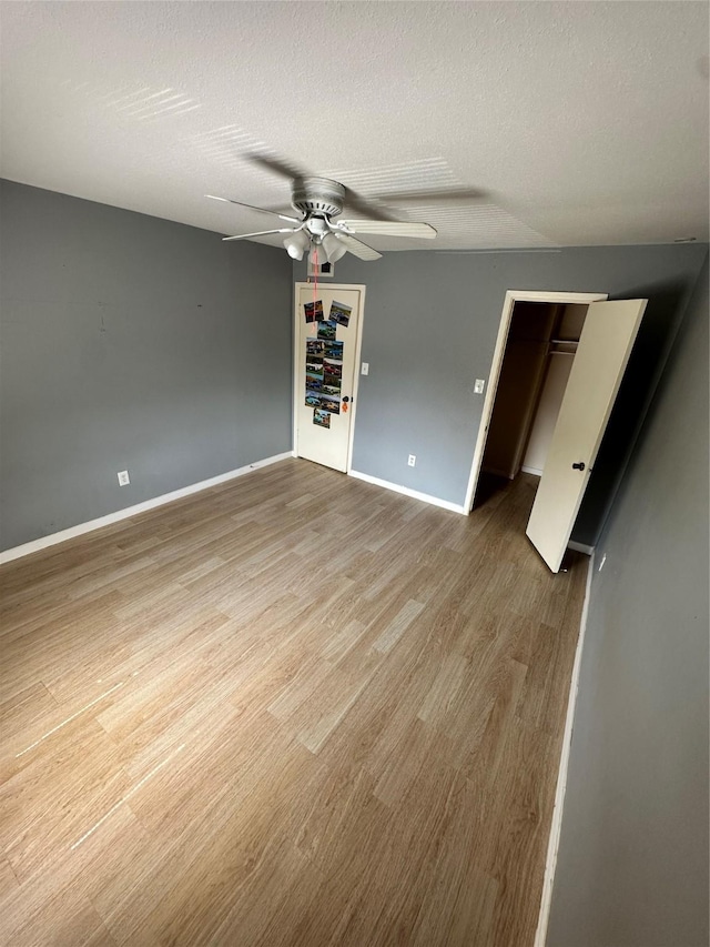 6161 Reims Rd Unit 611, Houston, TX 77036 - unfurnished bedroom with wood finished floors, ceiling fan, a spacious closet, and a closet