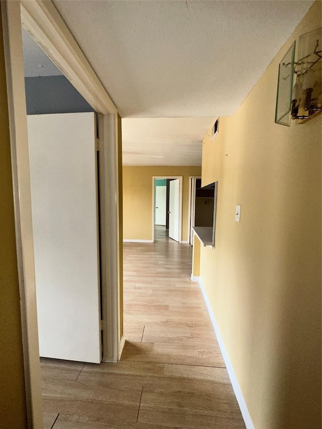 6161 Reims Rd Unit 611, Houston, TX 77036 - hallway featuring light wood-style flooring and baseboards