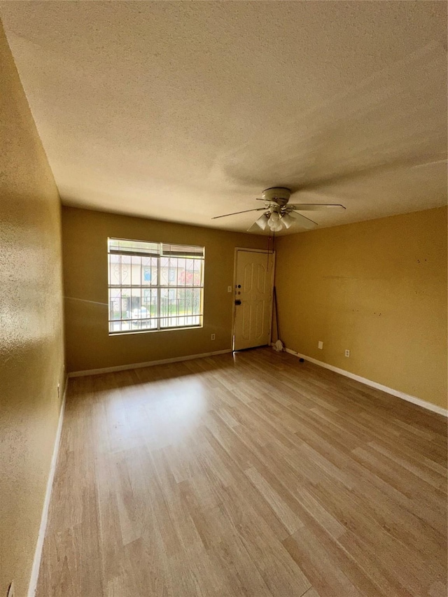 6161 Reims Rd Unit 611, Houston, TX 77036 - spare room with wood finished floors, ceiling fan, and a textured ceiling