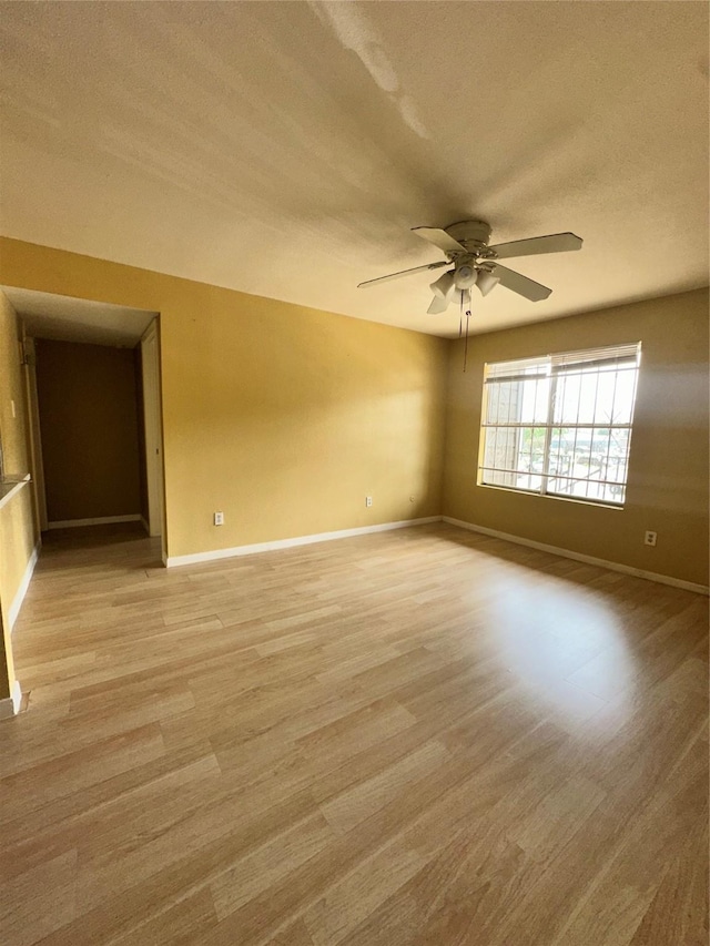 6161 Reims Rd Unit 611, Houston, TX 77036 - spare room featuring light wood-style flooring, ceiling fan, and a textured ceiling