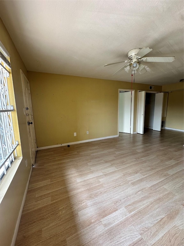 6161 Reims Rd Unit 611, Houston, TX 77036 - empty room featuring ceiling fan, wood finished floors, and a textured ceiling