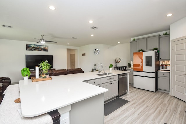3819 Ethan Park Ct, Katy, TX 77494 - kitchen featuring freestanding refrigerator, dishwasher, light countertops, open floor plan, and gray cabinetry