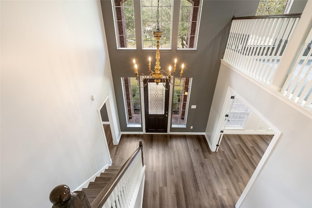 12014 Via Davinci Ln NW, Cypress, TX 77429 - foyer with a chandelier, a high ceiling, wood finished floors, and stairway