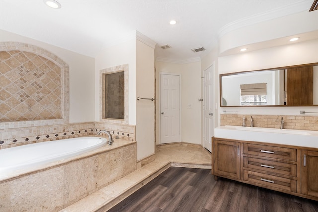 12014 Via Davinci Ln NW, Cypress, TX 77429 - full bath with a bath, vanity, recessed lighting, ornamental molding, and wood finished floors