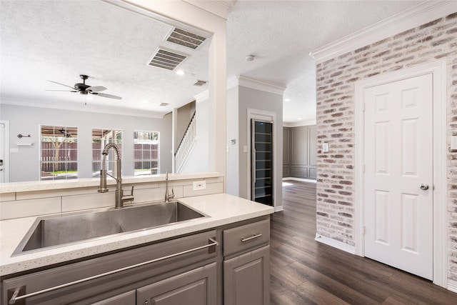 12014 Via Davinci Ln NW, Cypress, TX 77429 - kitchen featuring a textured ceiling, dark wood finished floors, a ceiling fan, gray cabinets, and light countertops