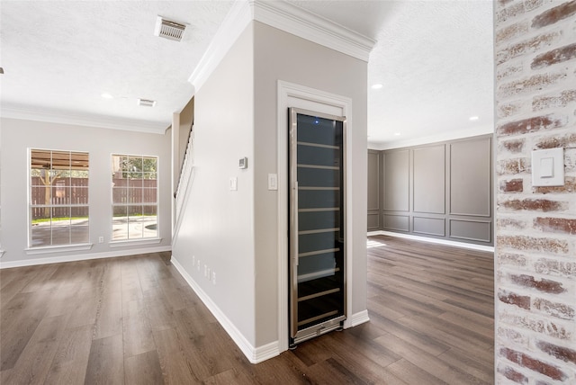 12014 Via Davinci Ln NW, Cypress, TX 77429 - hall with crown molding, dark wood finished floors, a textured ceiling, and recessed lighting
