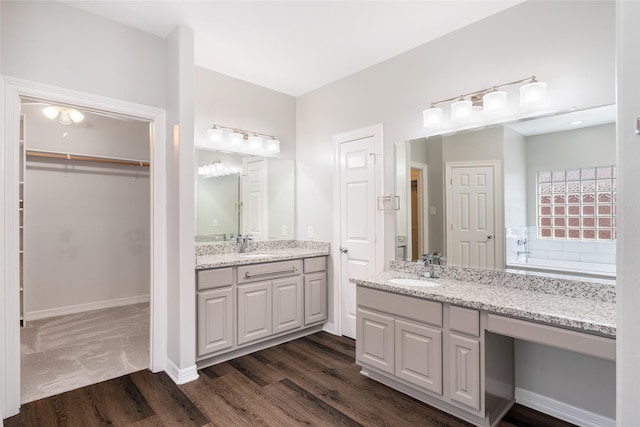 12014 Via Davinci Ln NW, Cypress, TX 77429 - bathroom featuring wood finished floors, vanity, and a spacious closet