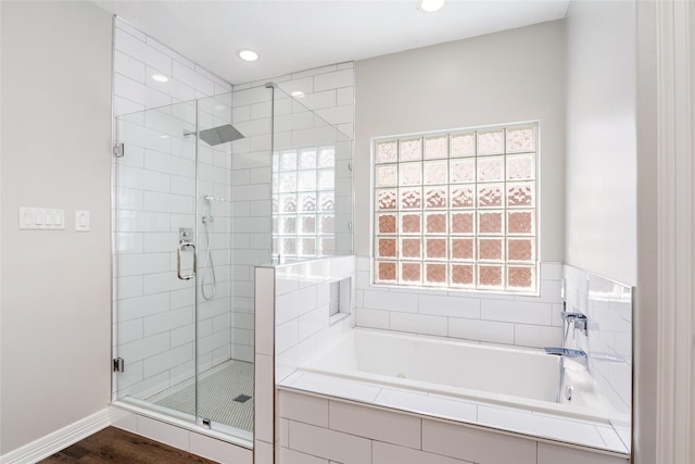 12014 Via Davinci Ln NW, Cypress, TX 77429 - bathroom with a shower stall, a bath, recessed lighting, and wood finished floors