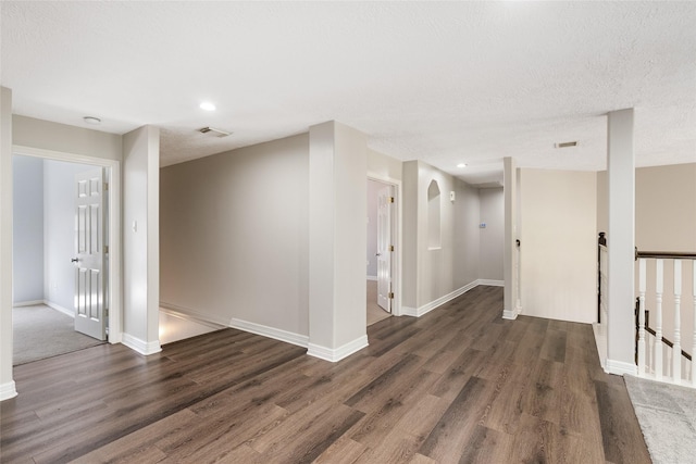 12014 Via Davinci Ln NW, Cypress, TX 77429 - spare room with wood finished floors, arched walkways, recessed lighting, and a textured ceiling