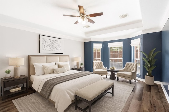 12014 Via Davinci Ln NW, Cypress, TX 77429 - bedroom with a tray ceiling, dark wood-type flooring, and a ceiling fan