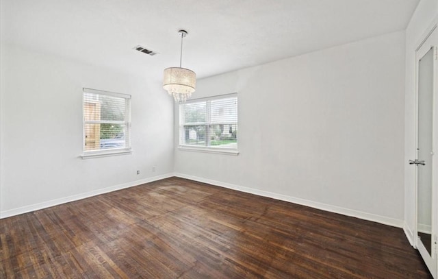 3818 Childress St, Houston, TX 77005 - spare room with dark wood-type flooring and a chandelier