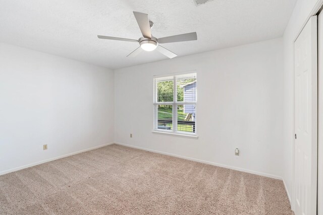 426 Apollo Dr, Livingston, TX 77351 - unfurnished room with light colored carpet, ceiling fan, and a textured ceiling