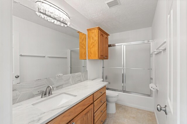 426 Apollo Dr, Livingston, TX 77351 - full bath featuring vanity, bath / shower combo with glass door, and a textured ceiling