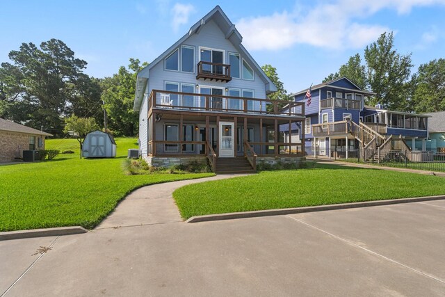 426 Apollo Dr, Livingston, TX 77351 - view of front facade featuring a storage shed, a front lawn, a porch, and a balcony