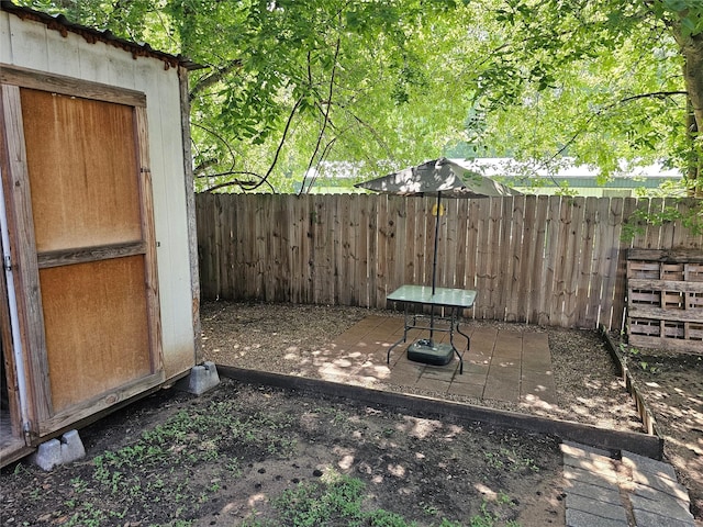 11670 Vistawood St, Willis, TX 77318 - fenced backyard featuring a storage unit and a patio area